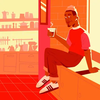 Man sitting on kitchen counter holding a cup of coffee