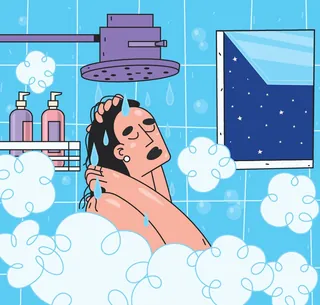 Man washing hair under shower with night sky visible