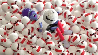 Nike shoes among many white and red sports balls by Maurice Baltissen