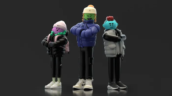 Three colorful figurines dressed in winter clothes by Maurice Baltissen