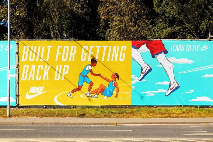 Nike advertisement billboard featuring basketball and running scenes by Max Erwin