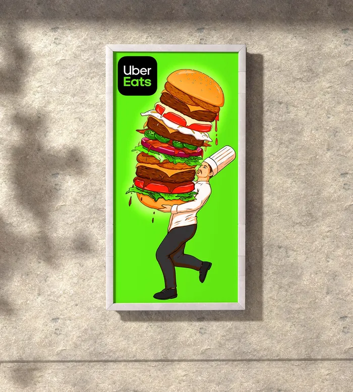 Chef holding oversized stacked burger with Uber Eats logo by Max Erwin