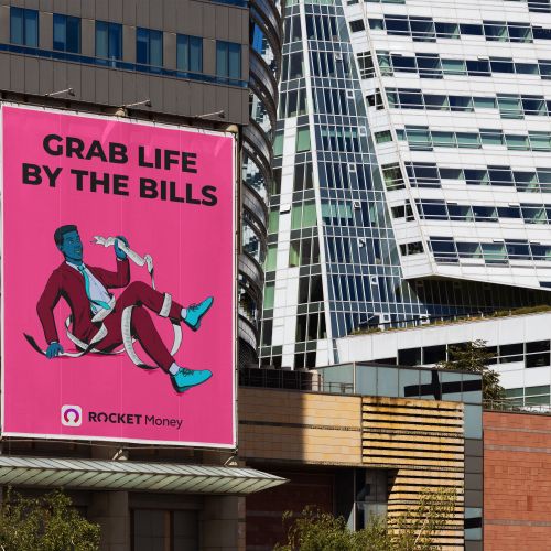 Outdoor billboard with Rocket Money ad saying Grab Life by the Bills by Max Erwin