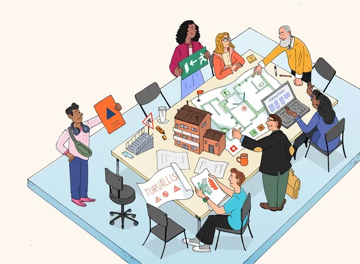 Group collaborating on architectural plans around a table