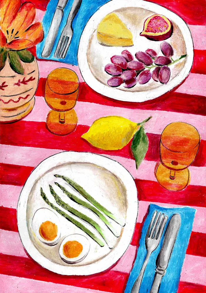 Colorful table with plates of fruit, eggs, asparagus, and glasses