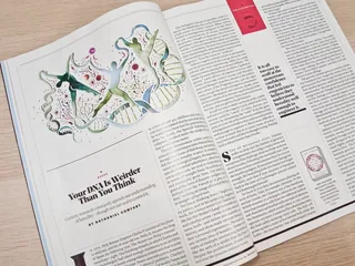 Open magazine featuring DNA illustration and article text