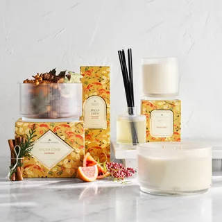 Spiced cider scented candles and reed diffuser with autumn decor