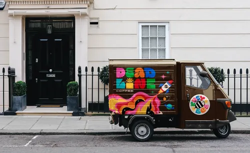 Deadline Coffee delivery truck with vibrant colorful logo and design by Mel Cerri
