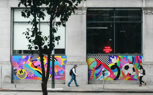 Street murals with vibrant Nike-themed illustrations by Mel Cerri