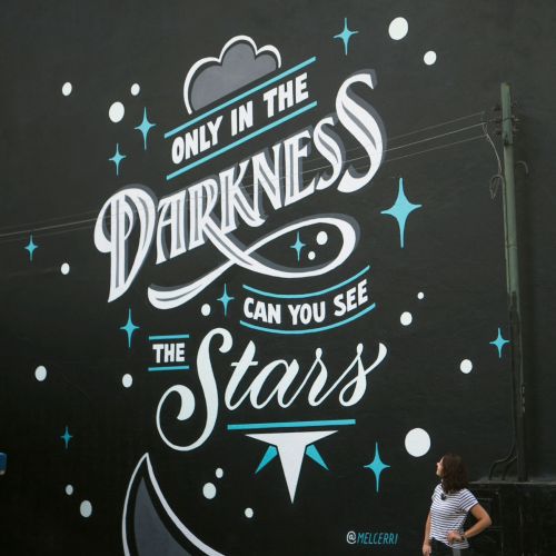 Mural with luminous text and stars by Mel Cerri