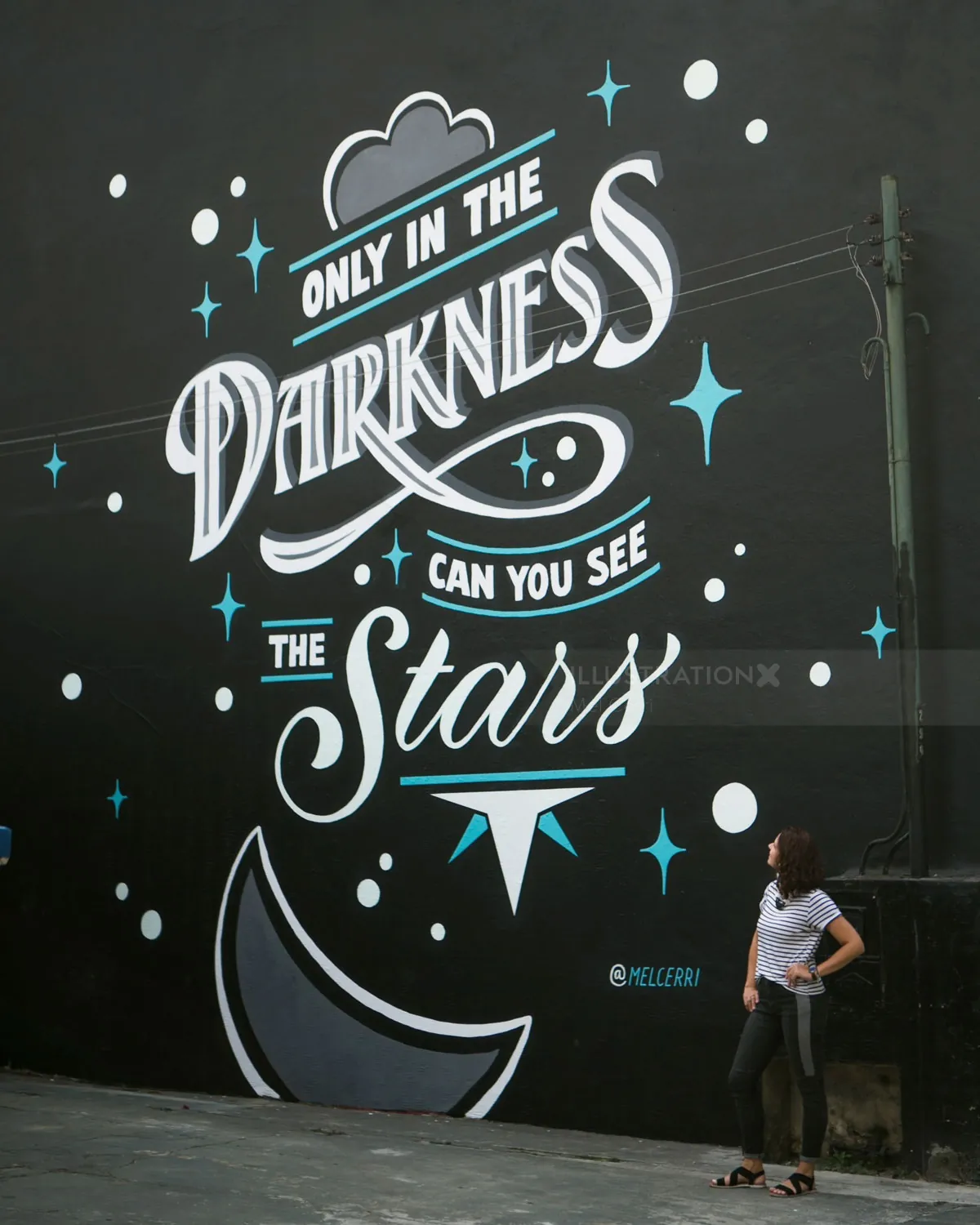 Mural with luminous text and stars by Mel Cerri