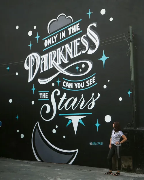Mural with luminous text and stars by Mel Cerri