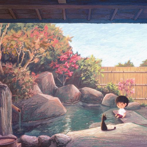 Boy sitting near pond with a black cat in a garden