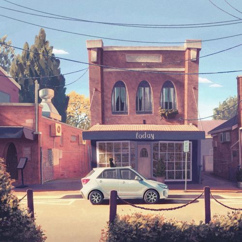 Small town building with white car parked on the street