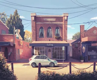 Small town building with white car parked on the street