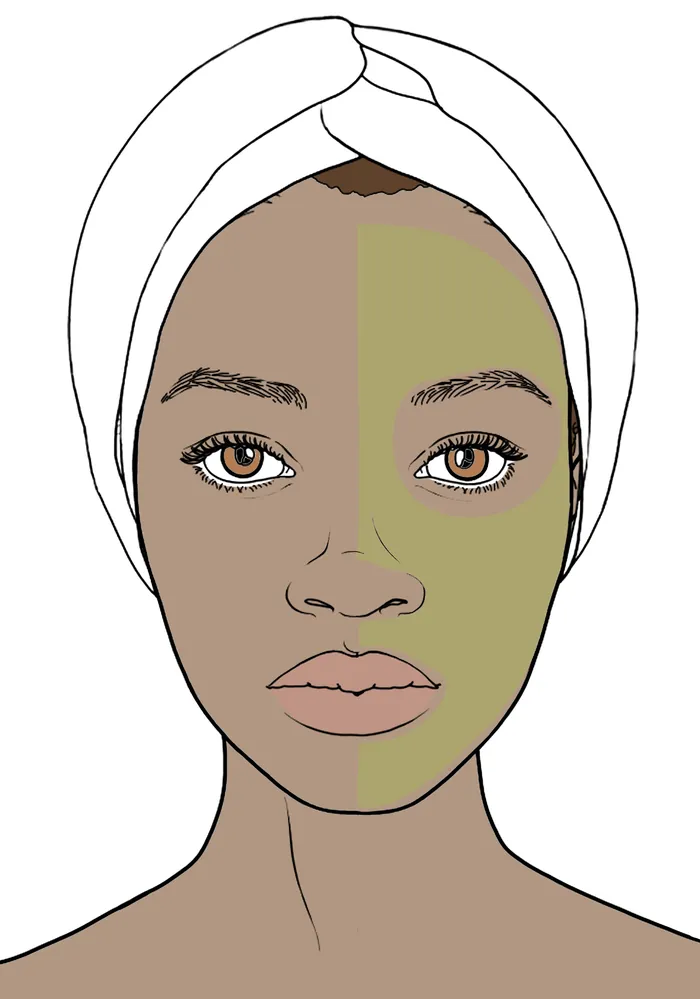 Woman with towel and half green facial mask applied
