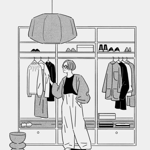 Woman choosing clothes in a neat wardrobe with hanging garments