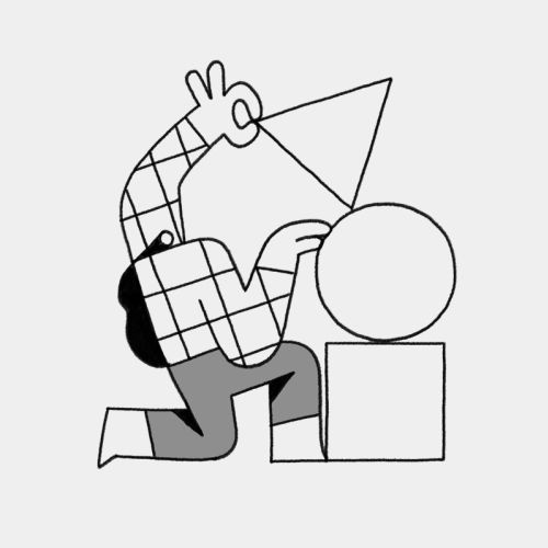 Person fitting a triangle shape onto a cube next to a circle shape.