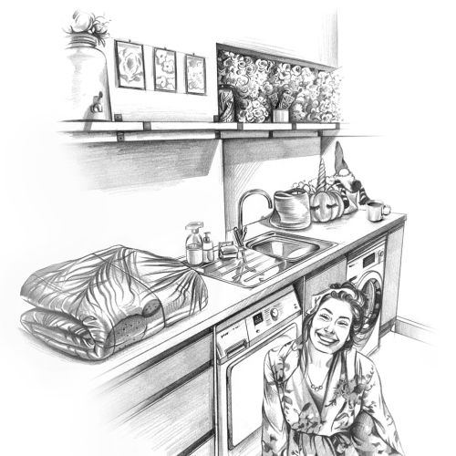 Woman sitting near washing machine with folded clothes on counter