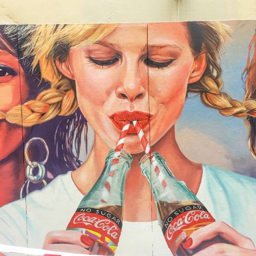 Mural illustration of woman drinking coca cola