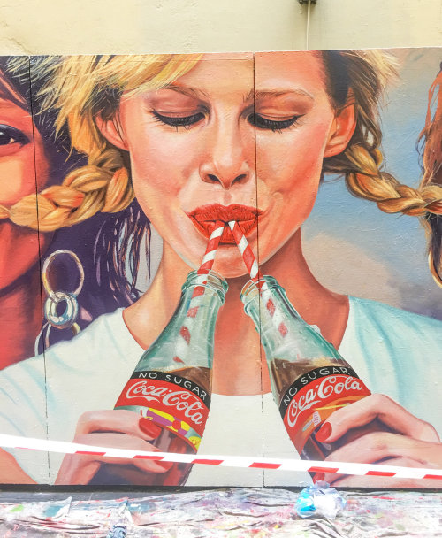 Mural illustration of woman drinking coca cola