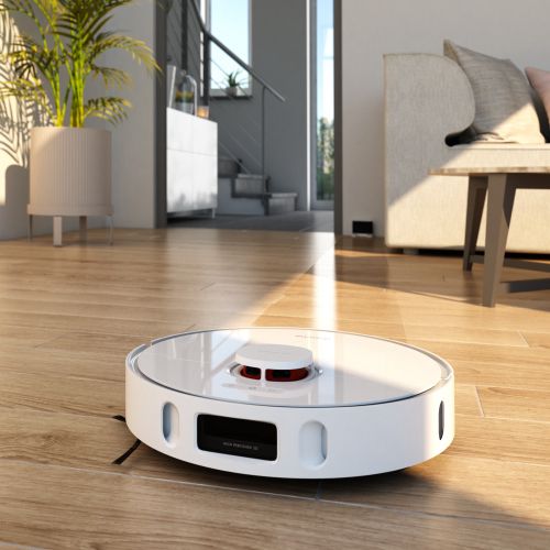 White robot vacuum cleaner on hardwood floor in living room by Oliver Hasselluhn