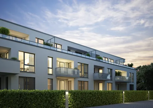 Modern apartment building exterior with balconies at dusk by Oliver Hasselluhn