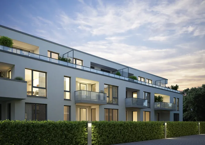 Modern apartment building exterior with balconies at dusk by Oliver Hasselluhn