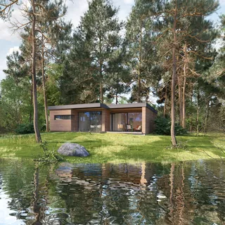 Modern cabin near lake with pine trees and reflections in water