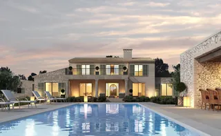 Luxury villa with outdoor pool and lounge area at sunset