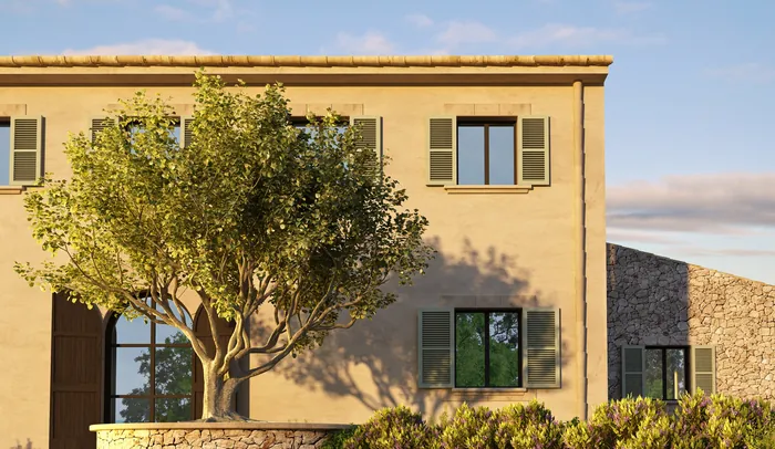 Two-story historic house with tree and clear sky