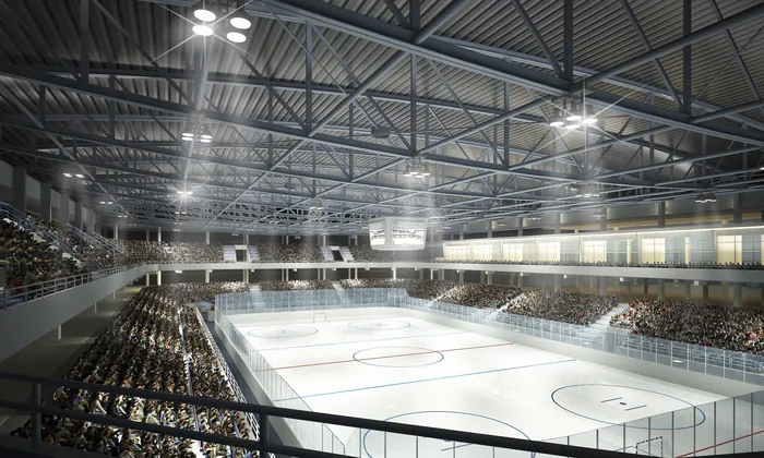 Empty indoor ice hockey rink with spectator seats and lights