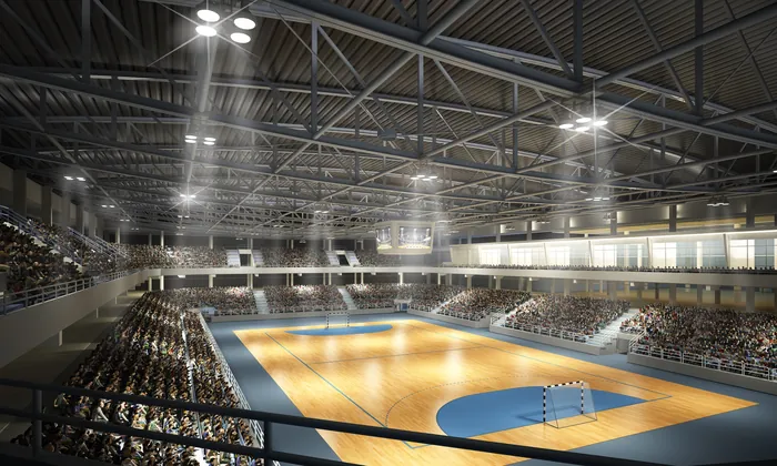 Indoor sports court with handball goal and audience seating