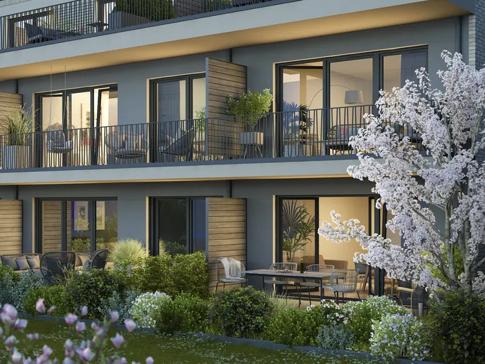 Modern apartment building with balconies and flowering garden
