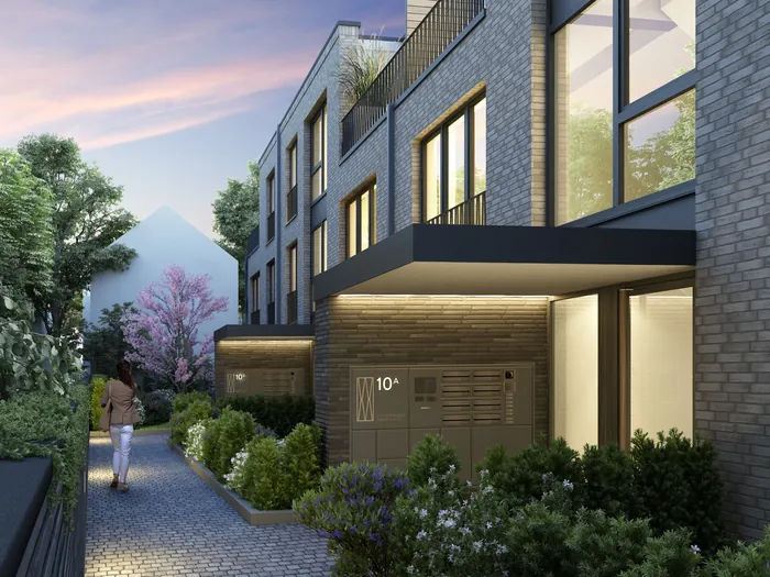 Modern townhouses with gardens and pathway at sunset