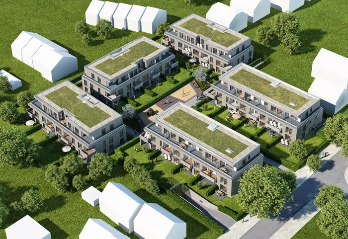 Aerial view of modern residential apartment complex with green roofs and trees