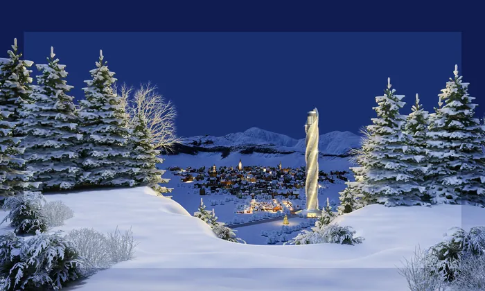 Snowy trees and landscape with illuminated village in the distance at night