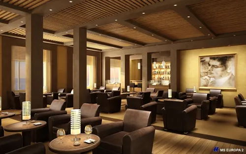 Modern lounge interior with dark armchairs and wooden tables by Oliver Hasselluhn