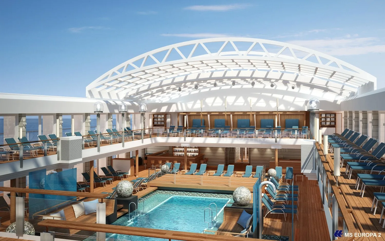 Indoor pool with lounge chairs and wooden deck on cruise ship by Oliver Hasselluhn