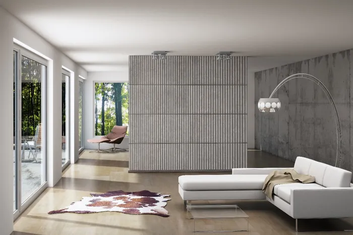 Modern living room with white sofa and large windows by Oliver Hasselluhn
