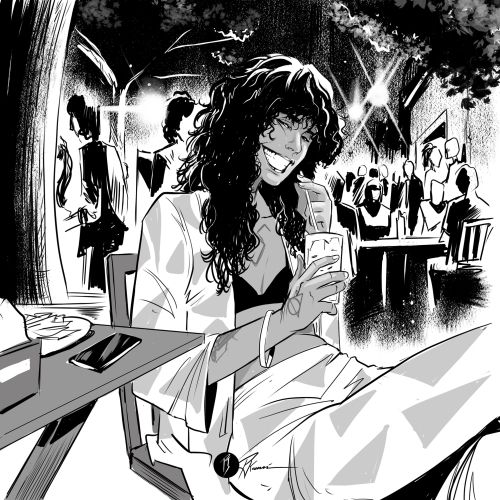 Woman with long hair smiling and holding a cup at outdoor cafe