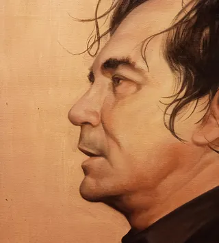 Side view portrait of a man with dark hair and neutral expression
