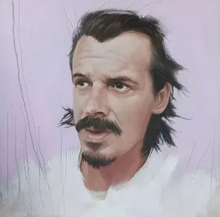 Portrait of a man with dark hair, mustache, and goatee on purple background