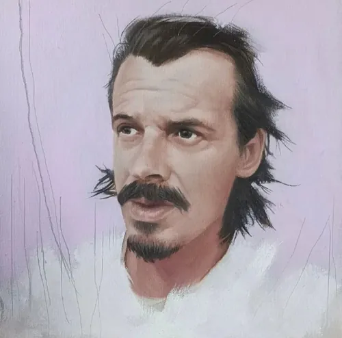 Portrait of a man with dark hair, mustache, and goatee on purple background