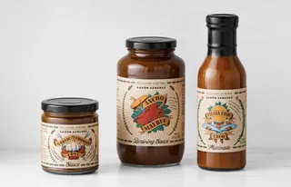 Three Aaron Sanchez sauce jars with vintage labels on white background