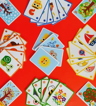 Colorful illustrated playing cards featuring cartoon designs by Pintachan