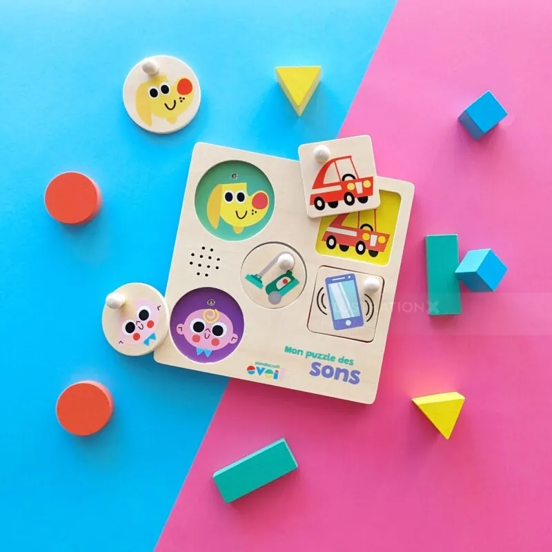 Children's sound puzzle with colorful pieces and vehicle images on blue and pink surface