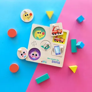 Children's sound puzzle with colorful pieces and vehicle images on blue and pink surface