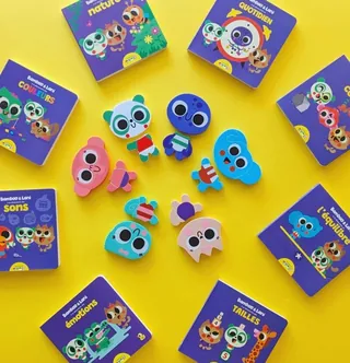 Cartoon animal toys and purple boxes arranged on yellow surface
