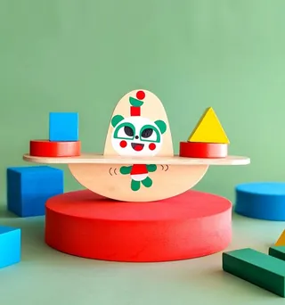 Wooden balancing toy with geometric shapes and panda illustration